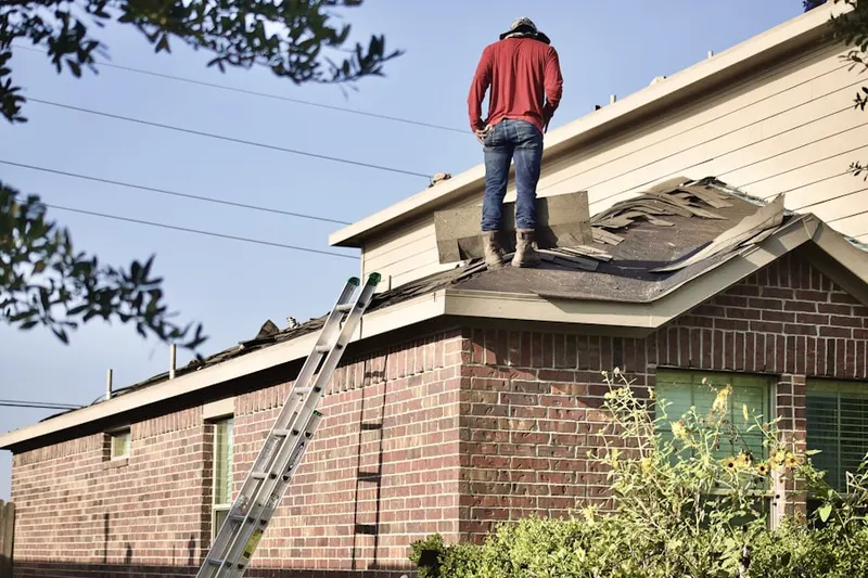 Professional roofer working on a residential roof in Pomfret Center